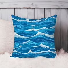 a blue pillow with white waves on it