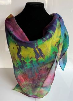 This hand painted silk scarf is made from luxurious and light-weight paj silk. This square scarf is finished with hand sewn edges, and is suitable for evening or day wear. Painted by Acacia Silks Tasmania, this unique scarf is impossible to replicate. The dyes used to paint this scarf have been fixed and the easy-care instructions are supplied with the item.