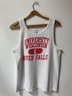 True vintage  1970's Champion Athletic singlet.  Front: "UNIVERSITY WISCONSIN L RIVER FALLS" 100% cotton, size Large.  Back: Blank Tag: Champion LARGE 100% cotton PTP:19" Length (top of shoulder strap to bottom hem) 25" Excellent vintage condition with one hole on front and two small stains all shown in photos. No refunds, returns or exchanges. You have options in shipping. We will only ship outside of North America with tracking. Retro Letter Print Tank Top, 90s Style Cotton Vest Tank Top, 90s Style Cotton Tank Top Vest, 90s Style Cotton Sleeveless Tank Top, 90s Sleeveless Cotton Tank Top, 90s Style Sleeveless Cotton Tank Top, 90s Style Cotton Vest Top, Vintage Spring Letter Print Tank Top, Vintage Cotton Tank Top For Summer