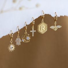 "Dainty Everyday Ear Stack Set, Personalized Initial Earrings, Evil Eye Cross Bee Hamsa Charm Huggies, bridesmaid gift, gold hoop earrings ✨These earrings feature a charm of your choice hanging from a dainty 18k Gold Plated huggie hoop. These hoops are sold as SINGLES, or by PAIRS - both options are available to select from the 2nd drop down menu. Mix & match these earrings to create fun and unique pairs! * Bezeled Moonstone Hoop Available to Purchase HERE: https://www.etsy.com/listing/125321249 Gift Drop Earrings With Dangling Charms, Huggie Earrings With Dangling Charms As Gift, Gold Dangle Huggie Earrings For Gift, Handmade Gold Huggie Earrings For Wedding, Gold Dainty Hoop Earrings For Gift, Dainty Gold Hoop Earrings For Gift, Gold Dangle Hoop Earrings For Wedding, Gold Crystal Pierced Earrings As Gift, Yellow Gold Earrings With Dangling Charms For Gift