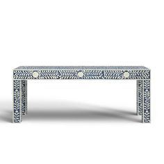 a blue and white table with an intricate design on the top, in front of a white background