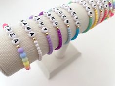 one colorful beaded name bracelet bracelets are made on a durable stretch elastic cord please refer to our sizing guide before purchasing Adjustable Friendship Bracelets With Letter Beads, Multicolor Name Bracelet With Letter Beads And Round Beads, Multicolor Name Bracelet With Round Letter Beads, Multicolor Name Bracelet With Letter Beads, Multicolor Stretch Bracelet With Round Beads, Trendy White 8mm Beads, Adjustable Name Bracelet With Colorful Beads, Adjustable Name Bracelet With Round Beads For Everyday, Casual Customizable Multicolor Jewelry