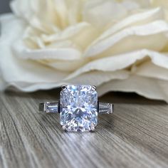 a cushion cut diamond ring with baguettes on the side