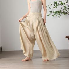 "Cool and comfortable for hot summer days, this apricot wide leg pants is elegant and stylish.    It is a wonderful wardrobe staple that's a timeless classic you'll wear again and again.  All our items are Tailored and Handmade and Made to Order ,I can make Any Size . I design new styles every week, please collect my store. I believe that you will meet your favorite styles. ★★FEATURES Tencel flax Has lining Two side pockets Front zipper closure Wide leg pants Apricot pants Casual pants Long pant Baggy High Waist Harem Pants For Vacation, Summer Ankle-length Harem Pants With Elastic Waistband, Baggy Summer Vacation Pants, Summer Vacation Baggy Pants, Baggy Wide Leg Pants For Beach, Baggy Summer Vacation Bottoms, Spring Summer Harem Pants With Relaxed Fit, Baggy Wide Leg Vacation Pants, High Waist Baggy Pants For Vacation