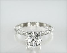 a diamond engagement ring on a white background