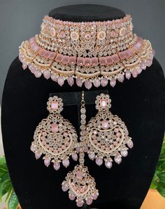 a necklace and earring set with pink stones