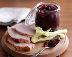 ham with cranberry sauce and celery on a cutting board