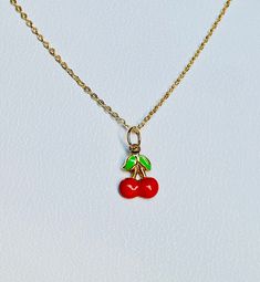 "A beautiful 14K solid yellow gold Red Cherry puffy charm / pendant with hand painted and baked enamel. It has a soldered ring to attach to a bracelet or a necklace. The small pendant measures 10mm (0.39\") tall with bail and without the soldered ring and 7.3mm (0.29\") wide. It can be used as a necklace pendant or a bracelet charm and would make a perfect gift. The pendant can be paired with a shiny 14K Yellow Gold 1.2mm cable link chain in either 16\" or 18\" length or with a 16\" 14K gold-pla Handmade Yellow Gold Enamel Necklaces, Handmade Yellow Gold Enamel Necklace, Cute Red Charm Necklace For Gift, Cute Red Charm Necklaces For Gifts, Cute Gold Jewelry With Vintage Charm, Cute Yellow Gold Jewelry Gift, Personalized Enamel Charm Necklaces For Gifts, Red Pendant Charm Necklace, Small Charms Jewelry For Gifts