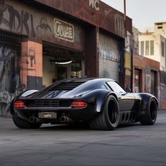 a black sports car parked in front of a building