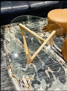 a glass coffee table with wooden legs on top