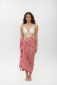 Crafted from lightweight cotton fabric, this sarong can be styled in multiple ways – wear it as a beach cover-up, a scarf, or a wrap skirt. The vibrant Aztec motif print adds a pop of color and pattern to your beach ensemble, making it a standout piece in your vacation wardrobe. Whether lounging by the pool or strolling along the shoreline, the Margot Sarong is the perfect companion for your next tropical getaway. Beachy Wrap Sarong For Beach Cover-up, White Floral Print Sarong For Beach Season, Bohemian Sarong With Tropical Print For Beach Season, White Floral Print Beachwear Sarong, Bohemian Tie-side Sarong For Vacation, Bohemian Wrap Scarves For Summer, Tropical Tie-side Sarong For Beach Cover-up, Bohemian Tropical Print Sarong For Beach Party, Spring Bohemian Sarong With Tie-side Bottom