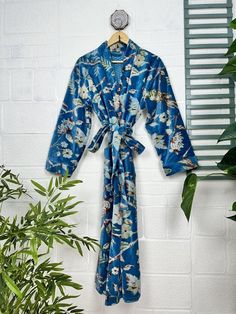 Indulge in the luscious luxury of our printed velvet robe, featuring a soft Silk lining. With its reversible design, you can choose between the stunning outer print or the comforting feel of the lining against your skin. Perfect for autumn and winter, this dressy robe is also a great choice for unpredictable cold weather. ONE SIZE Length: 50" Inch approx Chest: 50" Inch approx Sleeve: 21" Inch approx Our robe features two convenient pockets and a generous length of belt for easy home lounging.  It's also perfect for bridal makeup sessions and new moms during winter maternity.  Please note that this robe is not lightweight.  We strive to accurately capture the colors in our photography, but please be aware that screen resolution may slightly affect the appearance. We take our photos in natu Blue Floral Print Robe For Home, Blue Valentine, Printed Velvet, Winter Maternity, Braut Make-up, Valentine Love, Winter Gift, Womens Robes, Kimono Jacket