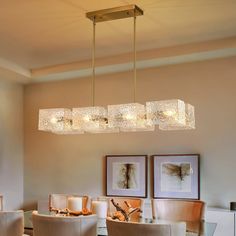 a chandelier hanging over a dining room table