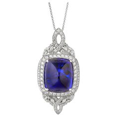 This collection features a selection of the most tantalizing Tanzanites. This enchanting East African gemstone can only be procured from one mine in the foothills of Mount Kilimanjaro, Tanzania. We have accented the rich purple-blue hues of this gemstone with diamonds set in white gold to present a rich and regal look. Classic tanzanite pendant in 18K white gold with diamonds. Tanzanite: 67.25 carat cushion sugarloaf shape, 23.14X19.45mm size. Diamonds: 4.042 carat, G colour, VS clarity. Gold: 1 Luxury Tanzanite Pendant Jewelry, Luxury Cutdana Pendant Jewelry, Luxury Tanzanite Pendant Necklace, Luxury Tanzanite Necklaces With Prong Setting, Kilimanjaro Tanzania, Tanzanite Pendant, Mount Kilimanjaro, Gold For Sale, Diamond Jewelry Designs