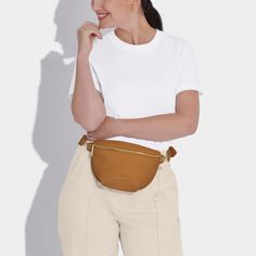 Our Maya Belt Bag in Black is here to accompany you on every summer adventure. With a captivating selection of six warm-weather ready colorways, this vegan leather gem effortlessly blends fashion with functionality. The adjustable wide strap guarantees a comfortable fit, while the internal pocket ensures effortless organization of small essentials. The gold-tone zip fastening not only adds a touch of elegance but also secures belongings, allowing for carefree dancing at festivals and beyond Versatile Belt Bag With Adjustable Strap For On-the-go, Brown Belt Bag With Detachable Strap For On-the-go, Satchel Belt Bag With Zipper Closure, Casual Brown Satchel Belt Bag, Beige Leather Belt Bag For On-the-go, Versatile Satchel Belt Bag For On-the-go, Versatile Satchel Belt Bag With Zipper Pocket, Everyday Belt Bag With Detachable Strap, Versatile Belt Bag With Adjustable Strap For Travel