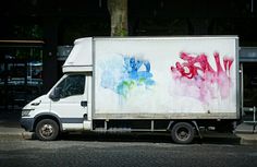 a delivery truck with graffiti on the side