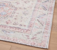 an area rug on the floor with wooden floors and wood planks in the background