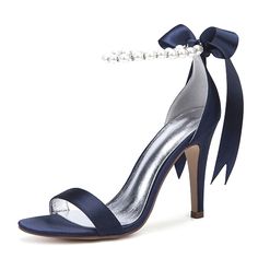 a women's high heeled sandal with a bow and pearls on the ankle