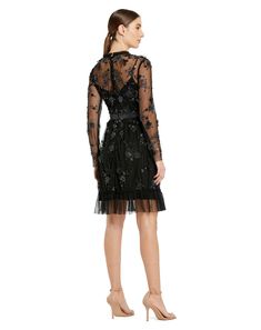 This exquisite dress features delicate sheer long sleeves that add a touch of allure, while intricate embellishments create a captivating sparkle. The flattering midi length makes it perfect for cocktail parties, formal events, or special occasions. Mac Duggal Embellished Mesh Overlay; 100% polyester lining Fully-lined bodice, sheer sleeves High neckline Long sleeve Floral embellishments with beaded detailing Ruffled/detailed hem Approx. 40" from top of shoulder to bottom hem Available in Black Black Mac, Beaded Mini Dress, Embellished Midi Dress, Long Sleeve Cocktail Dress, Sheer Long Sleeve, Designer Prom Dresses, Mac Duggal, Tea Length Dresses, Guest Dress