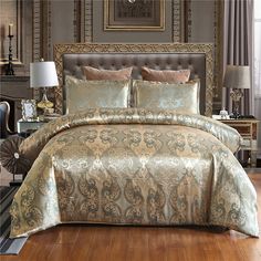 a large bed sitting on top of a hard wood floor next to a wall mounted clock