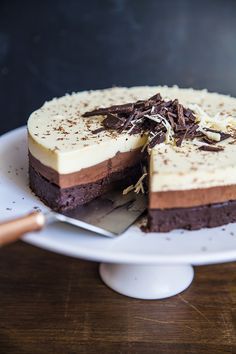 a chocolate and white cake on a plate with a knife