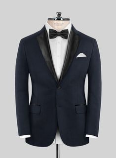 Set your style ablaze with the irresistible allure of the Napoleon Dark Blue Wool Tuxedo Suit. Meticulously crafted from the finest premium wool, this tuxedo features a deep, rich blue hue that adds a subtle yet striking visual appeal to your ensemble. Whether you're attending a black-tie gala, a luxury wedding, or a formal evening soirée, the Napoleon Dark Blue Wool Tuxedo Suit is your ticket to commanding attention and making an unforgettable impression.  Featuring satin lapel, matching satin Elegant Tailored Three-piece Suit For Evening, Tailored Elegant Three-piece Suit For Evening, Elegant Fitted Blue Tuxedo, Elegant Blue Fitted Tuxedo, Fitted Tuxedo With Suit Collar For Evening, Fitted Tuxedo With Hidden Button Closure For Parties, Single Breasted Tuxedo For Wedding, Luxury Tailored Wedding Suit And Tie Accessories, Single-breasted Tuxedo For Wedding