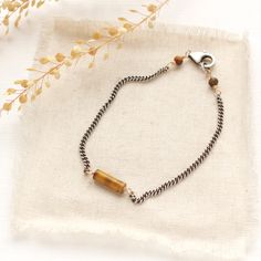 The perfect balance of modern and rustic. A moody tiger's eye is wrapped in gold and rests on an edgy curb chain. I love the contrast of the mixed metals against this stone! Finished with a lobster clasp and chain closure. Measures 7 1/2". Sterling silver, which has been oxidized and hand polished for an antique finish and 14k gold fill. About Tiger’s eye : Tiger's Eye, much like the eyes of a female cat, glitters with a small ray of light on the surface. This property of stone is known as chatoyancy. Tiger’s eye is golden brown with lustrous yellow and brown parallel fibers. Roman soldiers wore tiger's eye for protection in battle. Tiger’s eye was thought to be all seeing due to its appearance. About 14k gold fill: 14K gold filled wire is a professional jewelers grade wire. Gold filled wi Female Cat, Roman Soldiers, Tiger Eye Bracelet, Tiger's Eye, Antique Finish, Mixed Metals, Golden Brown, Curb Chain, Yellow And Brown