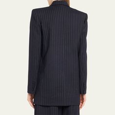 Oscar de la Renta tailoring jacket in an allover pinstripe finish features gold-tone buttons at front  Double-breasted front Peak lapel collar  Two-row button front  Long sleeves; button cuffs  Front welt pocket; side flap pockets  Back vent  Mid-length  Relaxed fit  Virgin wool/elastane Dry clean Made in Italy