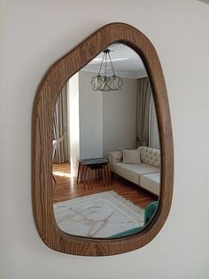 a mirror that is on the wall above a couch