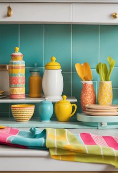 the kitchen counter is covered with colorful dishes and utensils, such as cups