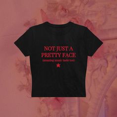 a black t - shirt that says not just a pretty face amazing music taste too