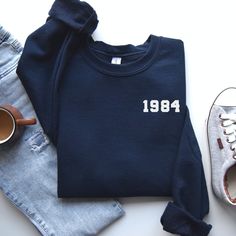 🎉 Celebrating a Milestone in Style - The Ultimate 40th Birthday Sweatshirt 🎉 Are you on the hunt for the perfect gift to celebrate a fabulous 40 years? Look no further! Our handcrafted 1984 Sweatshirt is the epitome of comfort meets celebration. Made with love and care, this cozy sweatshirt is not just a piece of clothing; it's a wearable hug that commemorates a special milestone. Ideal for those born in 1984, this 40th Birthday Gift Shirt is a unique and thoughtful present that will be cheris 40th Birthday Presents For Women, 40th Birthday Outfits For Women, 40th Birthday Gifts For Women, Birthday Outfit For Women, Birthday Sweatshirt, Spring Clothing, Birthday Gift For Women, Presents For Women, 40th Birthday Gifts