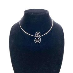 With its timeless style and high quality craftmanship, this vintage choker from AVON is sure to become a favorite piece in your jewelry collection. Circa 1978. Crafted with silver plated metal in a unique spun swirls design. A hook closure keeps it secure when worn. The choker measurement is 16" inches long and the Swirl Pendant is 1 1/2" inches by 7/8" inches wide. TO VIEW MORE FROM NEW VINTAGE FOR YOU, GO HERE: https://newvintageforyou.etsy.com Please note: All vintage items are sold as is in Elegant Spiral Metal Jewelry, Elegant Silver Spiral Jewelry, Elegant Silver Spiral Necklace, Silver Metal Choker As A Gift, Vintage Silver Beaded Choker, Vintage Silver Choker As Gift, Vintage Silver Choker For Gift, Silver Spiral Jewelry For Jewelry Making, Spiral Silver Jewelry For Jewelry Making