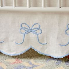 a white crib with blue bows on it