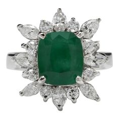 an emerald and diamond cluster ring