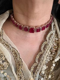 A symbol of feminism and elegance. Prepare yourself for the festive season with this Ruby CZ Choker Set with Earrings. Be it a gift, cocktail night or wedding reception this piece will add charm to your personality. Product Details: Material: Each piece is meticulously handcrafted from high-quality brass, CZ Stones. Necklace Dimensions: Weight: 45 grams. Closure Type: Premium Dori Adjustable Size: Yes  Earring Dimensions (Per Pair): Weight: 18 grams Length: 4 cm Width: 1.8 cm Closure Type: Push Gold Plated Jewelry For Party, Elegant Gold-plated Jewelry For Party, Elegant Gold Plated Jewelry For Party, Glamorous Rose Gold Necklaces For Party, Glamorous Rose Gold Party Necklace, Party Plated Jewelry, Elegant Party Necklaces With Hand Set Details, Elegant Hand-set Necklaces For Parties, Elegant Hand Set Necklaces For Party