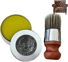 the shaving brush is next to a tin of wax and an old leather chair