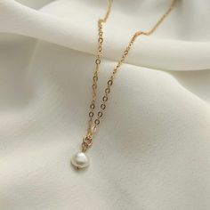 Express your love for pearls every day with this dainty & gorgeous freshwater pearl necklace. Beautifully crafted, it adds a touch of elegance - perfect for feminine and classic styling. The single pearl hangs from a fine gold filled chain. DIMENSIONS: Pearl: 6mm. Chain: 16-18" / 41-46cm (adjustable length). Pearl Necklace With Gold, Small Pearl Necklace, Single Pearl, Freshwater Pearl Necklace, Freshwater Pearl Necklaces, Gold Filled Chain, Pendant Necklaces, Gold Chain, Gold Chains