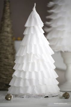 a white paper christmas tree sitting on top of a table