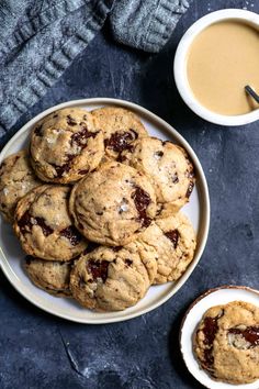 chocolate chip cookies on a plate next to a cup of coffee