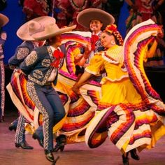 dancers in colorful costumes performing on stage