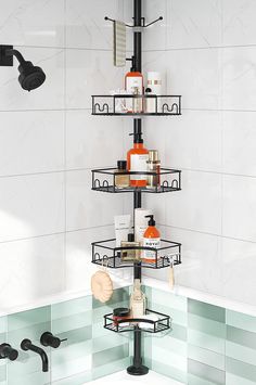 a bathroom with a shower head, soap and lotion bottles on the shelf next to the bathtub