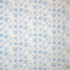 a blue and white background with snowflakes in the middle, on top of a sheet