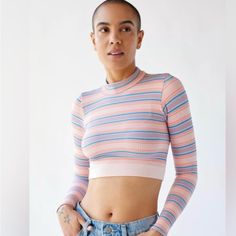 This Xs Urban Top Is A Stylish, Long-Sleeve Cropped Piece That Features A Vibrant Horizontal Stripe Pattern In Soft Pastels, Including Shades Of Pink, Blue, And White. The Ribbed Fabric Gives It A Textured Look, While The High Neckline Adds A Touch Of Sophistication. Perfect For Pairing With High-Waisted Jeans Or Skirts, This Top Combines A Playful Vibe With A Snug, Form-Fitting Silhouette, Making It Ideal For Casual Outings Or Layering Under Jackets. Urban Top, Mesh Long Sleeve Top, Mesh Long Sleeve, Urban Outfitters Women, Shades Of Pink, Urban Outfitters Tops, Puff Sleeve Top, Ribbed Fabric, Retro Dress