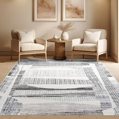 two chairs sitting on top of a rug in a living room next to a table