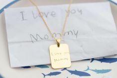 Our Handwriting Plate Necklace, crafted from high-quality silver, is the perfect way to preserve a special memory forever. Whether it's your child's first handwriting, drawing, or even their first expression of love, this necklace captures the moments that matter most. Measuring 1'' long and 0.6'' wide, the silver plate can be deeply engraved to ensure your message never fades or wears off. Not just for mothers, this necklace can feature the handwriting, message, or signature of a loved one, or even the name of a beloved pet--whatever memory you wish to keep close to your heart. This timeless piece serves as a meaningful tribute to the bond between you and those you cherish. A perfect gift for any occasion, this keepsake necklace offers unmatched durability and sentiment, ensuring it will Handwriting Drawing, Message Necklace, Handwriting Necklace, Handwriting Jewelry, Signature Necklace, Plate Necklace, Engraved Necklace, Custom Necklace, Name Necklace