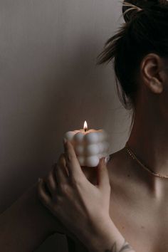 a woman holding a candle in her hand