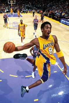 an autographed photograph of a basketball player on the court with other players in the background