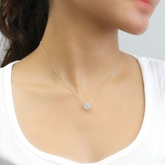 "925 Sterling Silver Platinum Plated; Platinum plating added to enhance shine and durability Top Quality Cubic Zirconia Pendant Dimension; 10mm wide X 10mm long The diamond equivalent in carat weight of this pendant is around 0.9 carat. The center stone size is a half-carat. Chain 16\"+2\" extension" White Necklaces With Sparkling Round Stones, Dainty Diamond White Flower Pendant Necklace, White Round Birthstone Necklace, Anniversary Round Pendant Flower Necklace, Dainty White Necklace With Sparkling Stones, White Crystal Necklace With Flower Pendant, White Crystal Flower Pendant Necklace, Silver Diamond Necklace With Flower Shape For Gift, Silver Diamond Necklace In Flower Shape