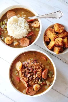 two bowls filled with different types of food on top of a white table next to each other